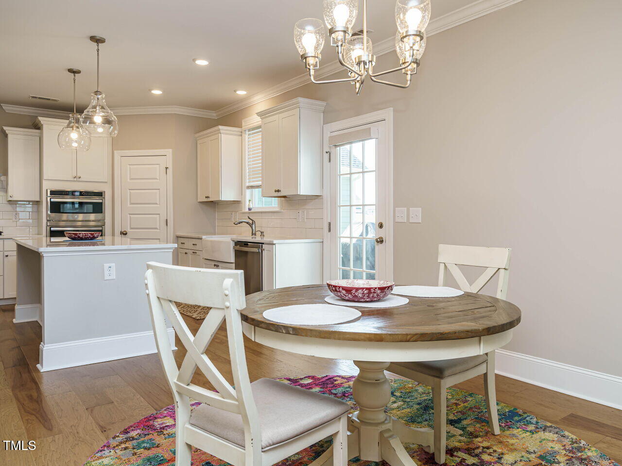 507 Dungannon Loop Clayton, NC 27520 - Photo 11 of 36 a dining room with furniture a chandelier and wooden floor