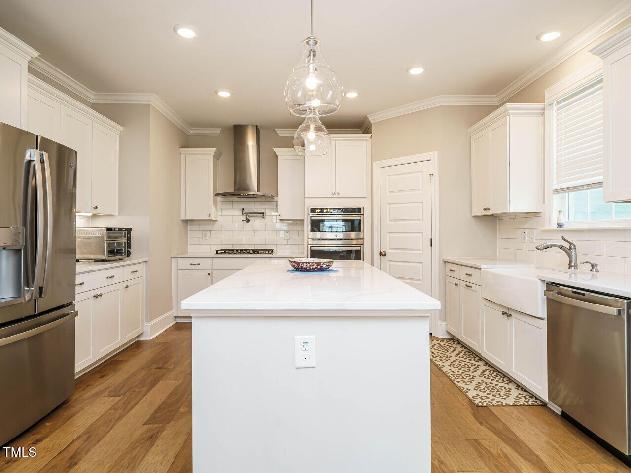 507 Dungannon Loop Clayton, NC 27520 - Photo 13 of 36 a kitchen with kitchen island sink stove and refrigerator