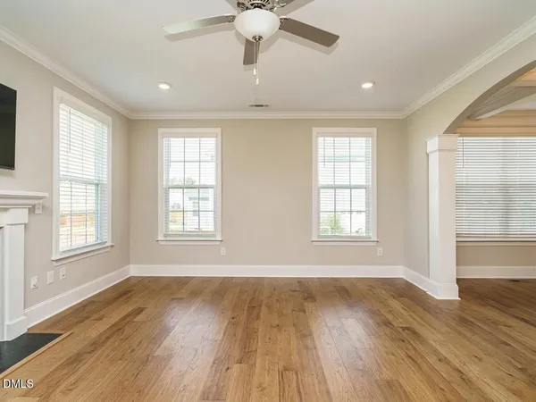 a spacious bedroom with a bed and a chandelier