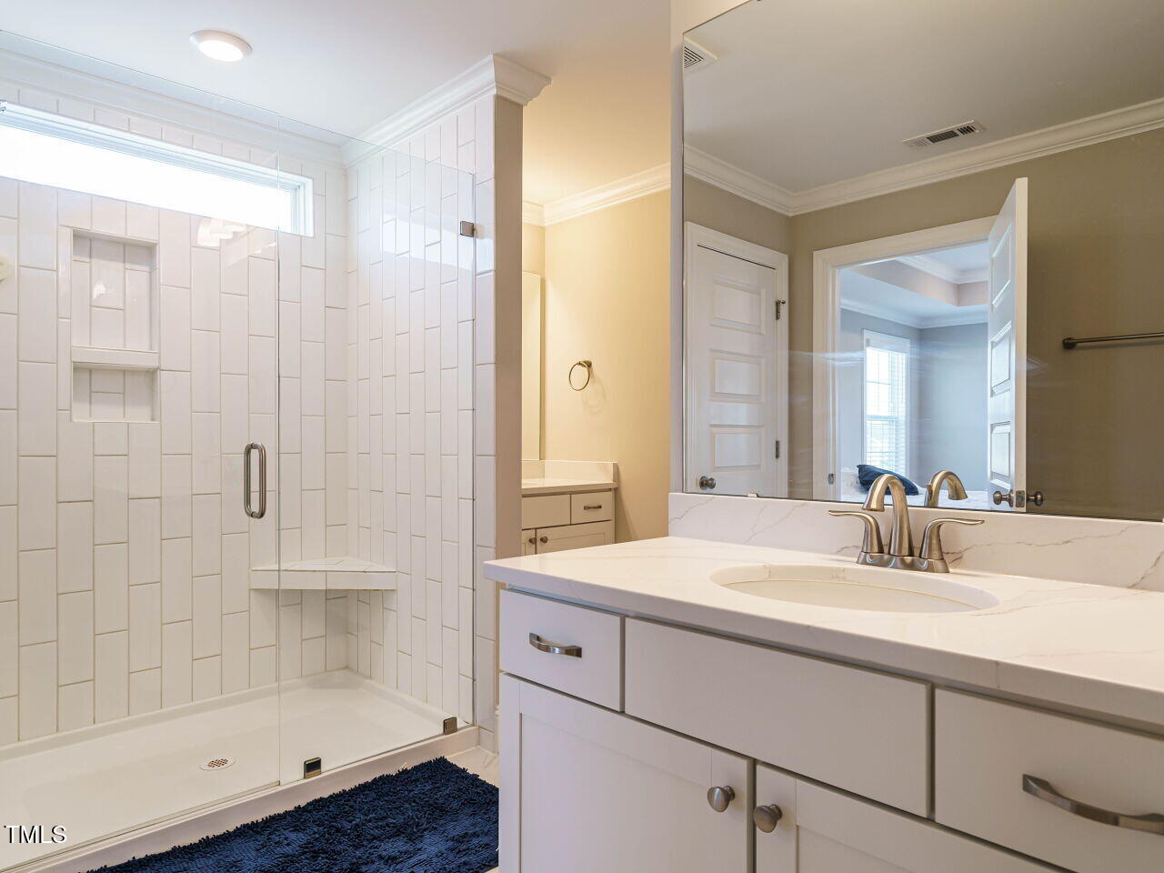 507 Dungannon Loop Clayton, NC 27520 - Photo 21 of 36 a bathroom with a shower sink and mirror