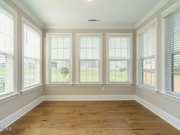 an empty room with a empty space and windows
