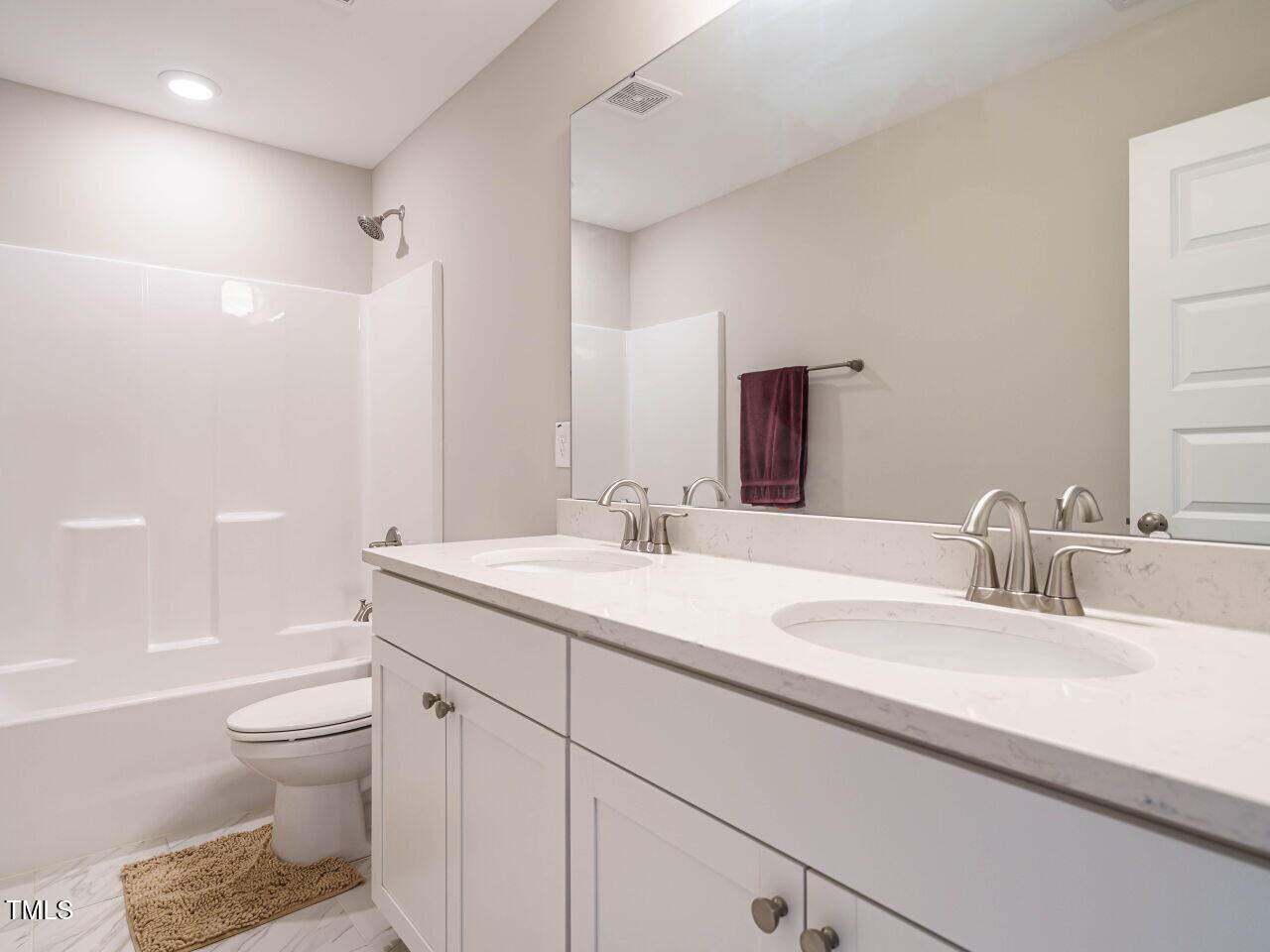 507 Dungannon Loop Clayton, NC 27520 - Photo 26 of 36 a bathroom with a granite countertop sink a toilet and a large mirror