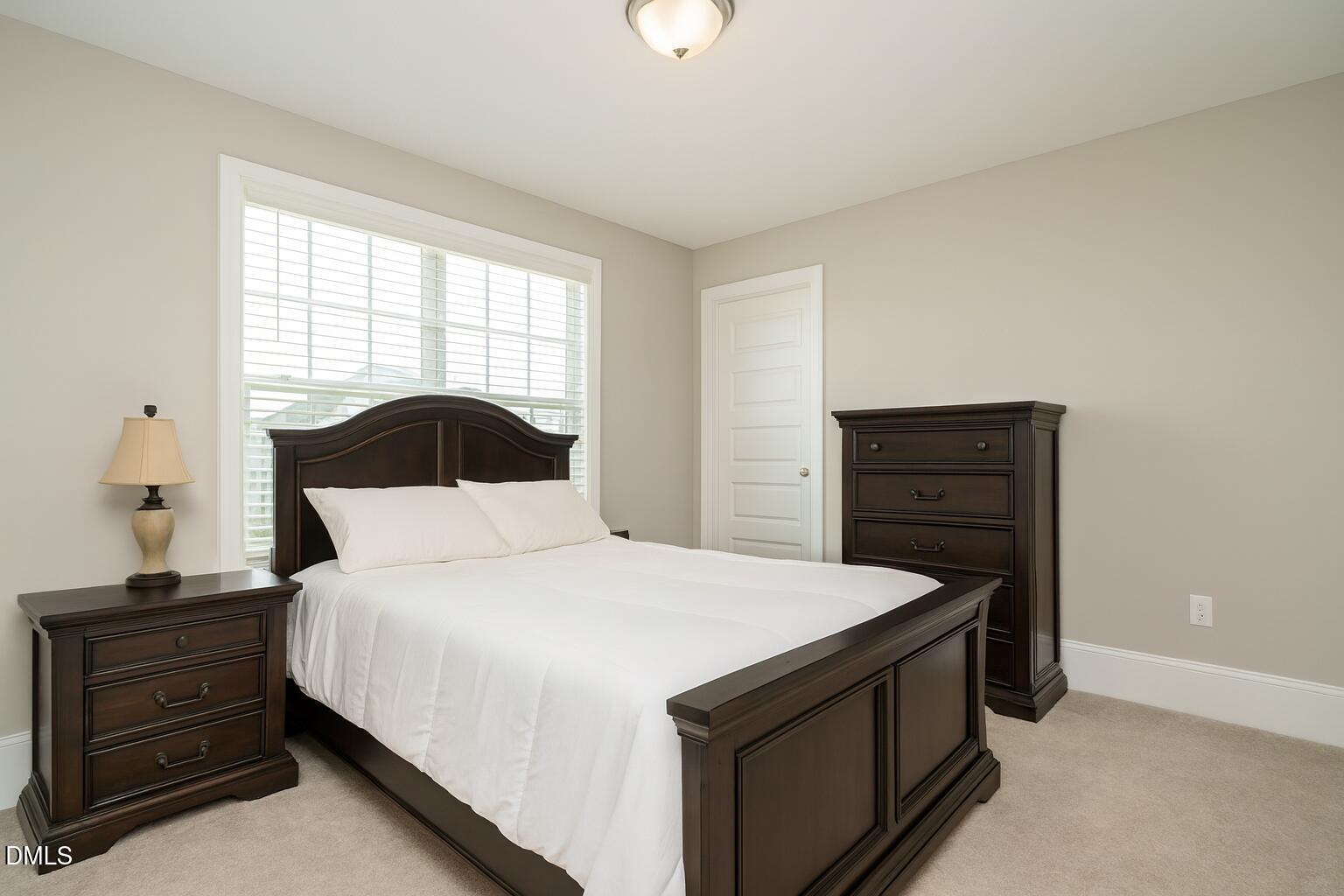 507 Dungannon Loop Clayton, NC 27520 - Photo 28 of 36 a bedroom with a bed and a window