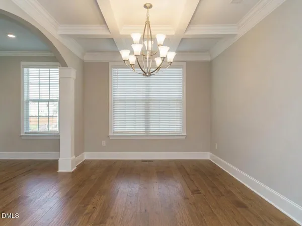 a kitchen with a sink a stove cabinets and wooden floor