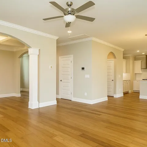 a view of empty room with wooden floor