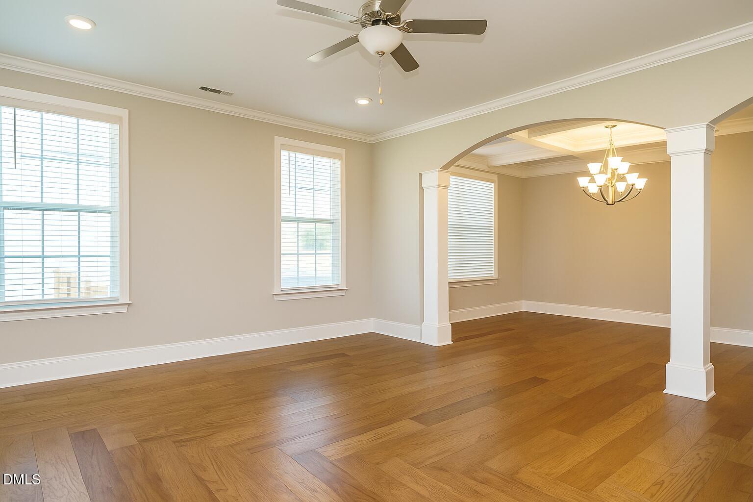 507 Dungannon Loop Clayton, NC 27520 - Photo 9 of 36 wooden floor in an empty room with a window