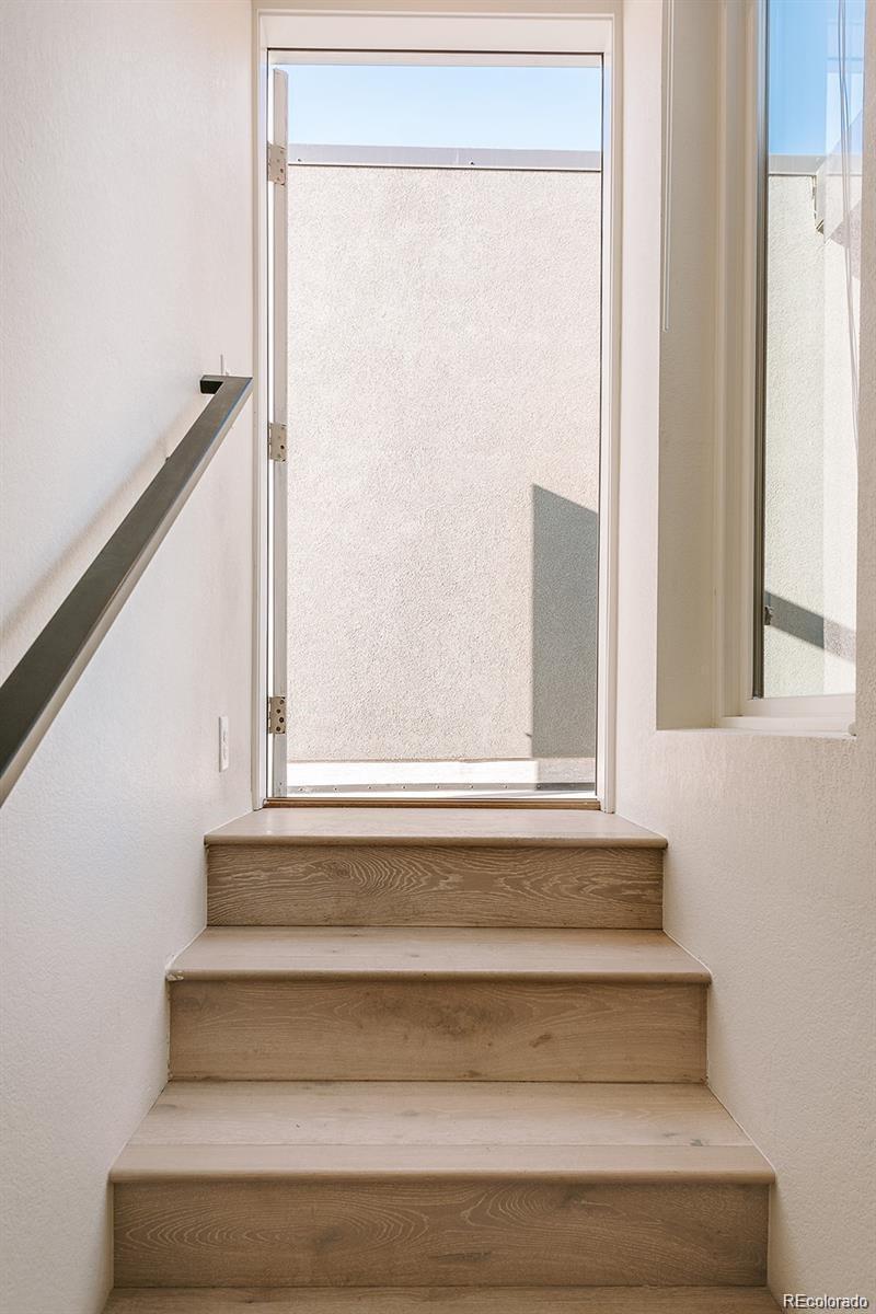 5125 West 29th Avenue, Unit 6 Denver, CO 80212 - Photo 24 of 26 a view of staircase with a fireplace