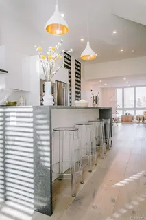 a kitchen with stainless steel appliances kitchen island granite countertop a table and chairs in it