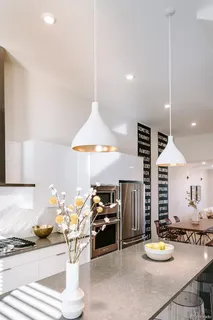 a kitchen with stainless steel appliances kitchen island granite countertop a stove and a sink