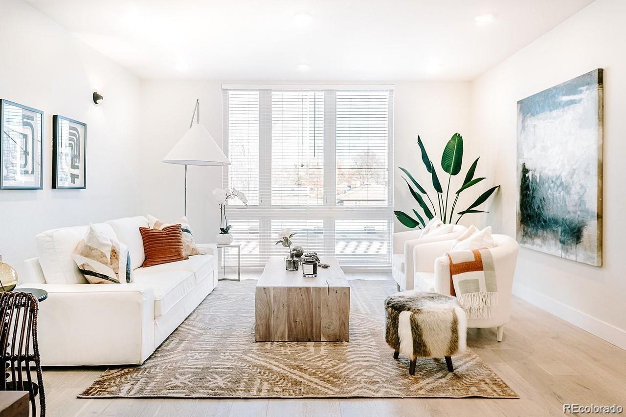5125 West 29th Avenue, Unit 6 Denver, CO 80212 - Photo 7 of 26 a living room with furniture a rug and a potted plant
