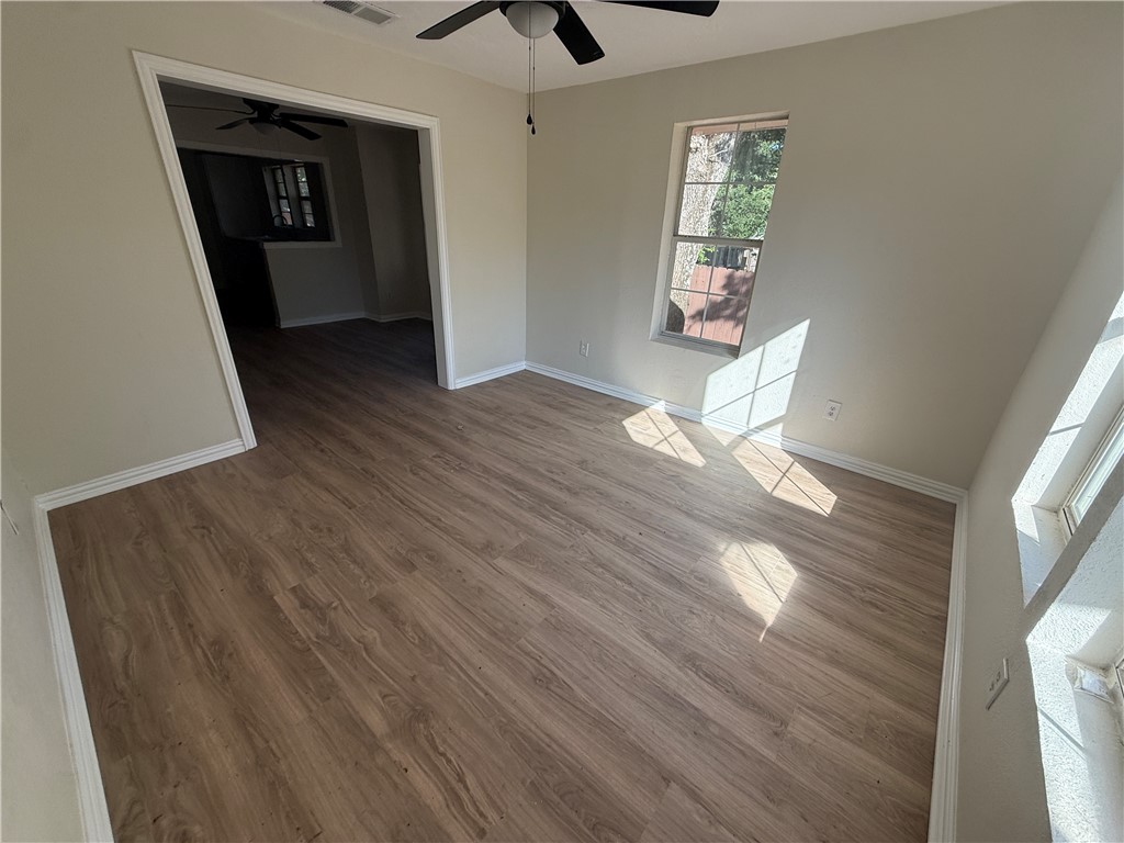 1613 Robeson Street Bryan, TX 77803 - Photo 2 of 18 a view of empty room with wooden floor and fan
