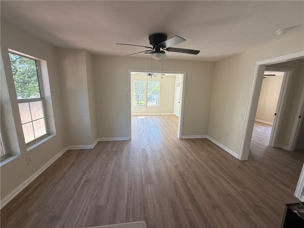 1613 Robeson Street Bryan, TX 77803 - Photo 3 of 18 a view of empty room with wooden floor and fan