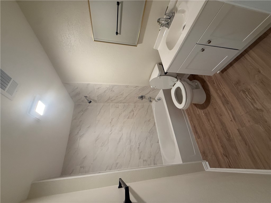 1613 Robeson Street Bryan, TX 77803 - Photo 4 of 18 a bathroom with a sink a toilet and shower