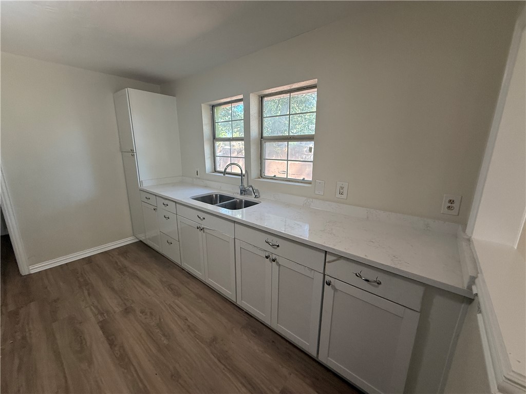 1613 Robeson Street Bryan, TX 77803 - Photo 8 of 18 a kitchen with granite countertop a sink and a stove top oven