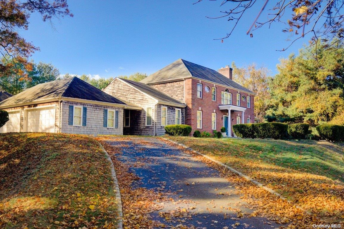 277 Piping Rock Road Locust Valley, NY 11560 - Photo 1 of 1 a view of a yard in front of a brick house with a large tree