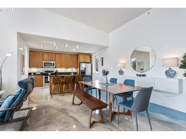 a view of a dining room with furniture and a large window