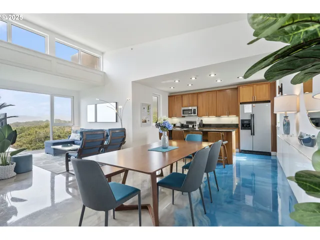 a dining area with stainless steel appliances kitchen island granite countertop a dining table and chairs
