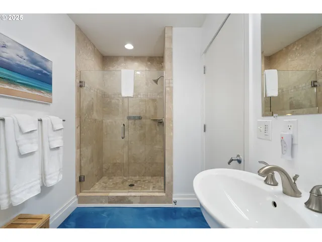 a bathroom with a shower a mirror and a sink