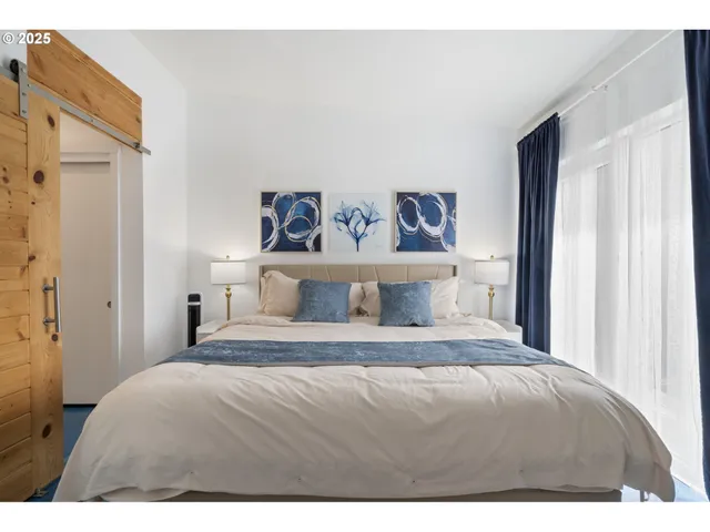 a bedroom with a large bed and a chandelier