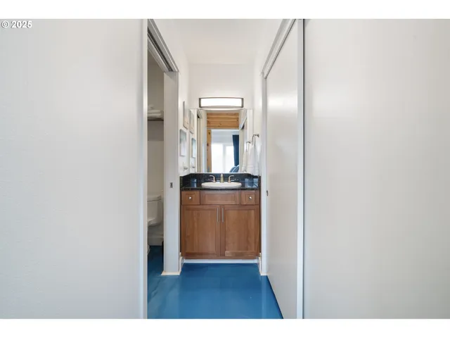 a bathroom with a granite countertop sink toilet a mirror and bathtub