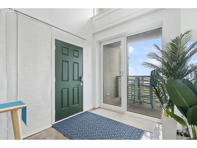 a view of a room that has a door and a window