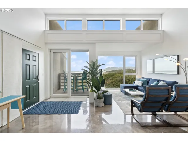 a living room with furniture a window and a potted plant