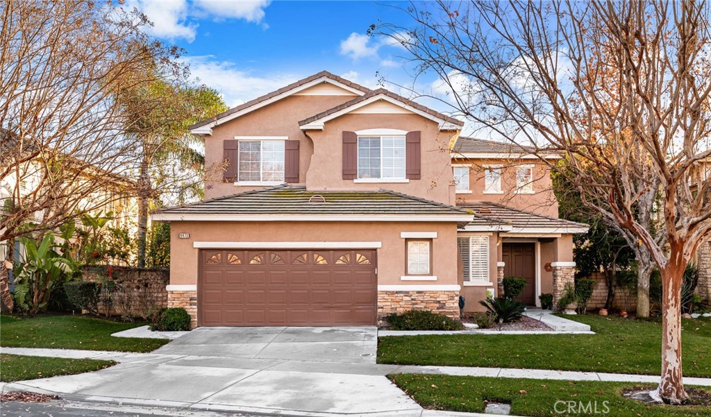 9473 Poppyfield Court Rancho Cucamonga, CA 91730 - Photo 1 of 1 a front view of a house with a yard and garage