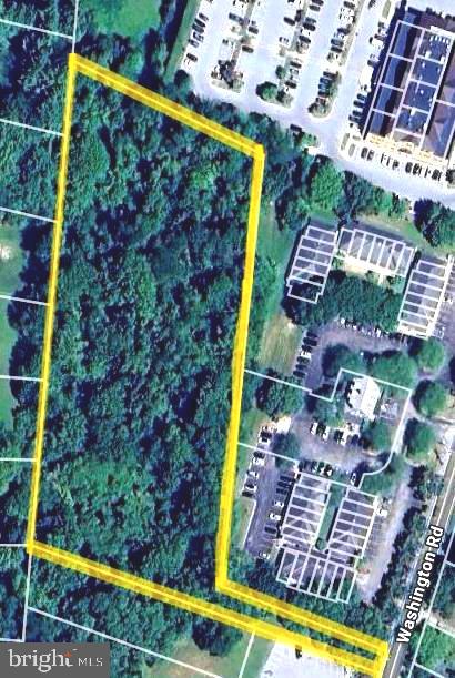 a view of swimming pool with lawn chairs and potted plants