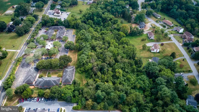 an aerial view of residential house with outdoor space and swimming pool
