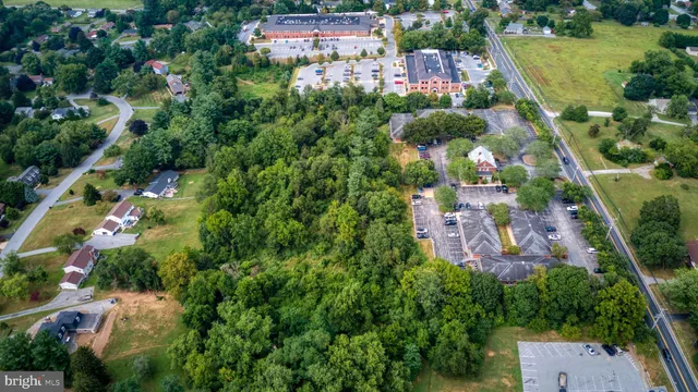 an aerial view of residential houses with outdoor space and street view