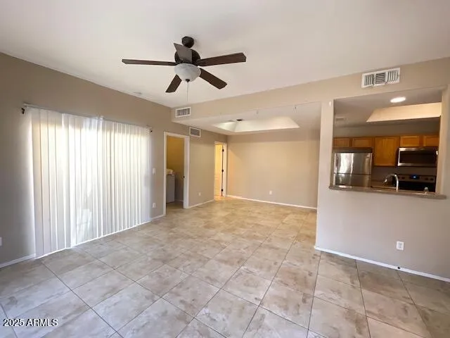 a view of a livingroom with a ceiling fan and window