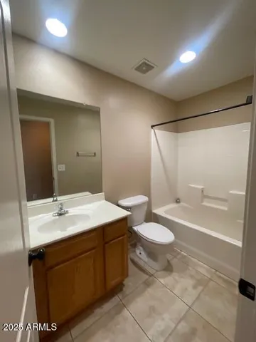 a bathroom with a double vanity sink toilet and a mirror