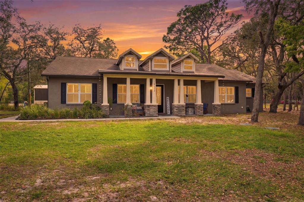 14582 Boland Avenue Spring Hill, FL 34610 - Photo 1 of 74 a front view of a house with a yard