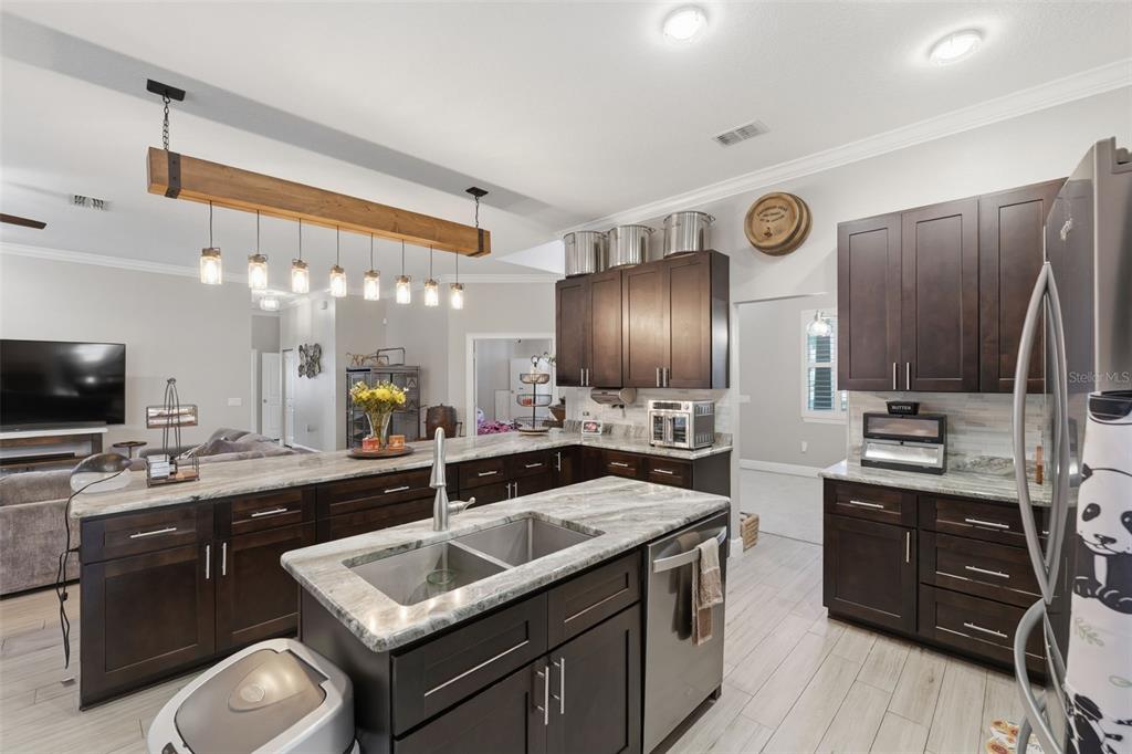 14582 Boland Avenue Spring Hill, FL 34610 - Photo 17 of 74 a kitchen with a sink stove and refrigerator