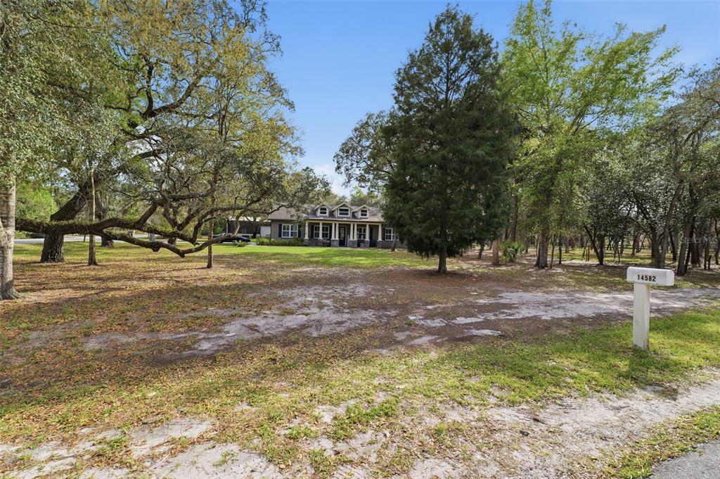14582 Boland Avenue Spring Hill, FL 34610 - Photo 2 of 74 a view of outdoor space with garden