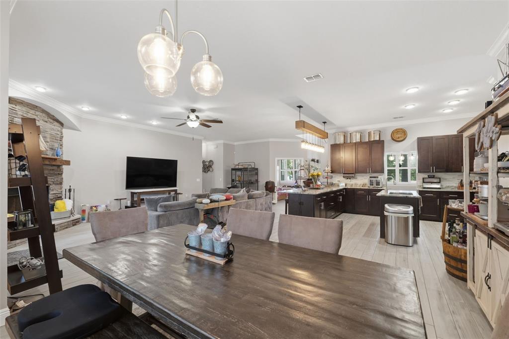14582 Boland Avenue Spring Hill, FL 34610 - Photo 23 of 74 a living room with lots of furniture and a flat screen tv
