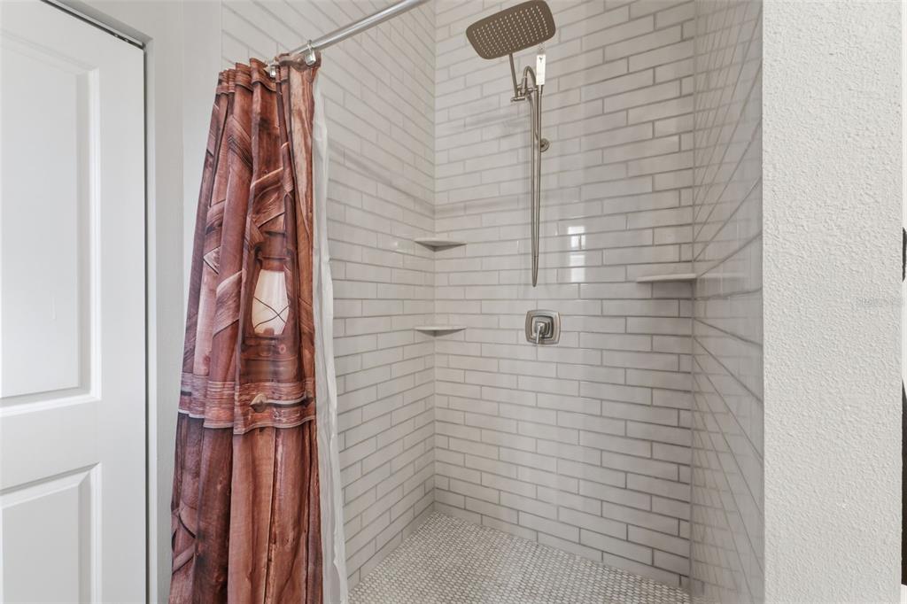 14582 Boland Avenue Spring Hill, FL 34610 - Photo 30 of 74 a bathroom with a shower and a shower curtain