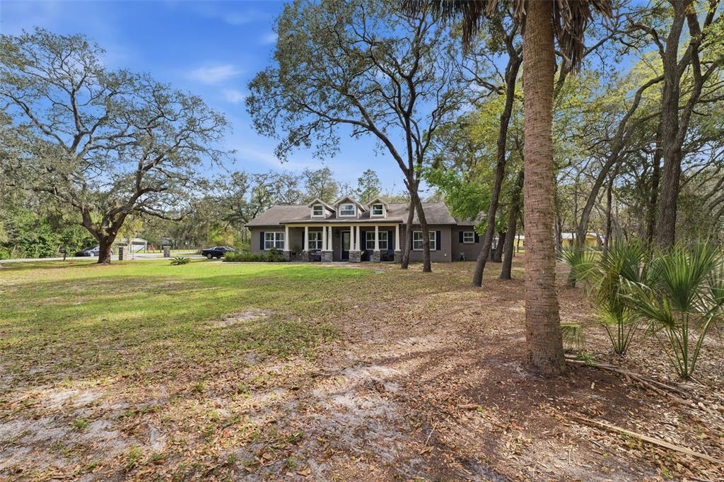 14582 Boland Avenue Spring Hill, FL 34610 - Photo 3 of 74 a view of a house with a yard
