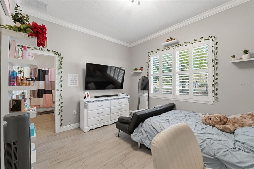 14582 Boland Avenue Spring Hill, FL 34610 - Photo 32 of 74 a bedroom with furniture and a flat screen tv