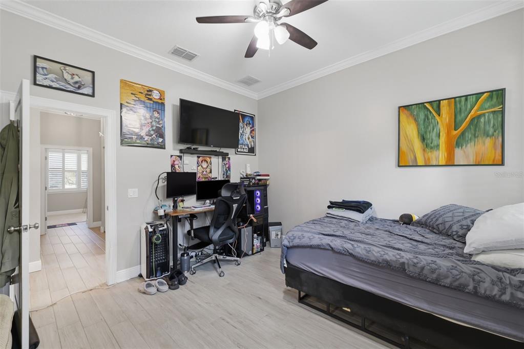 14582 Boland Avenue Spring Hill, FL 34610 - Photo 36 of 74 a bedroom with a bed and a flat screen tv