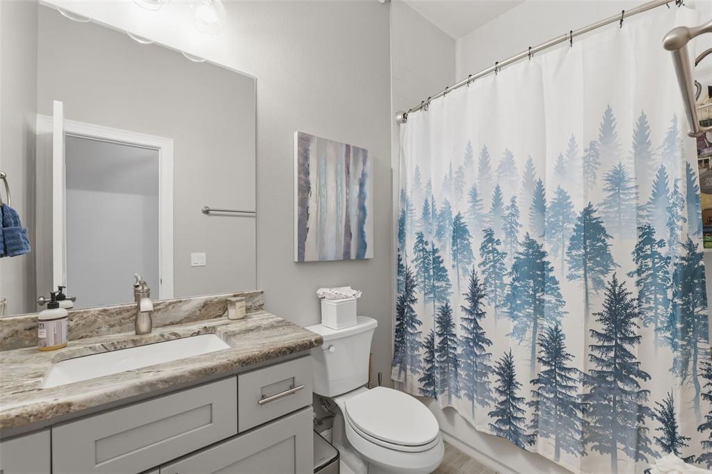 14582 Boland Avenue Spring Hill, FL 34610 - Photo 37 of 74 a bathroom with a granite countertop bathtub sink vanity mirror and toilet