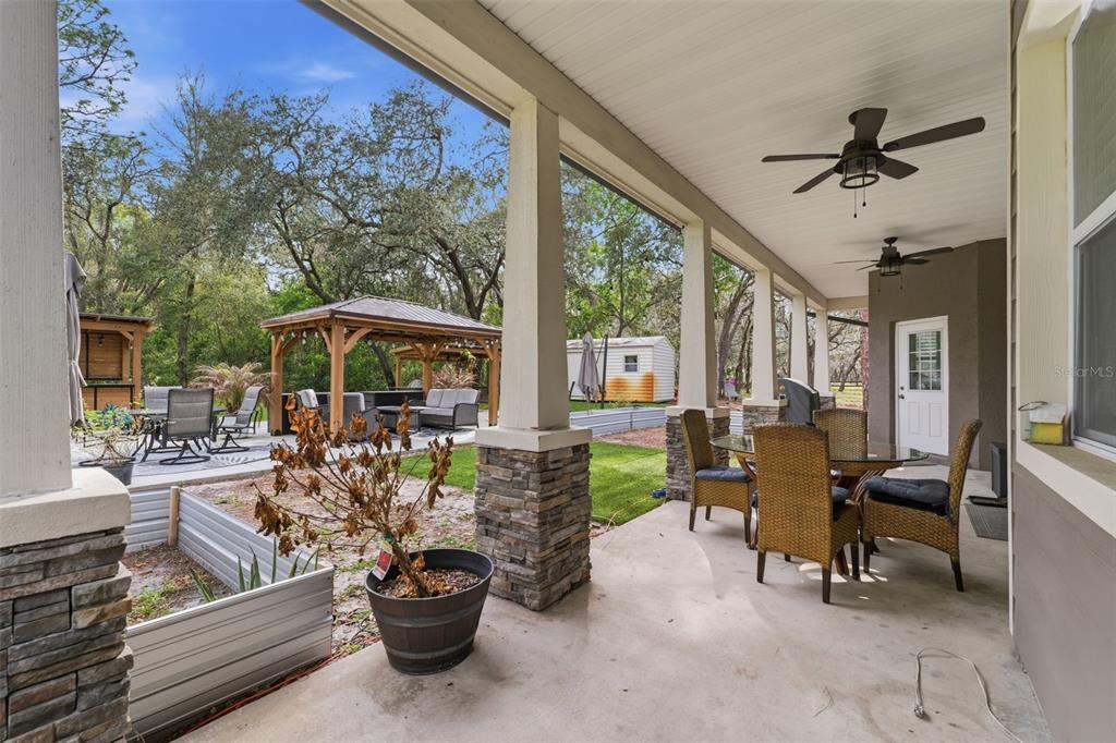 14582 Boland Avenue Spring Hill, FL 34610 - Photo 43 of 74 a living room with patio furniture and a potted plant