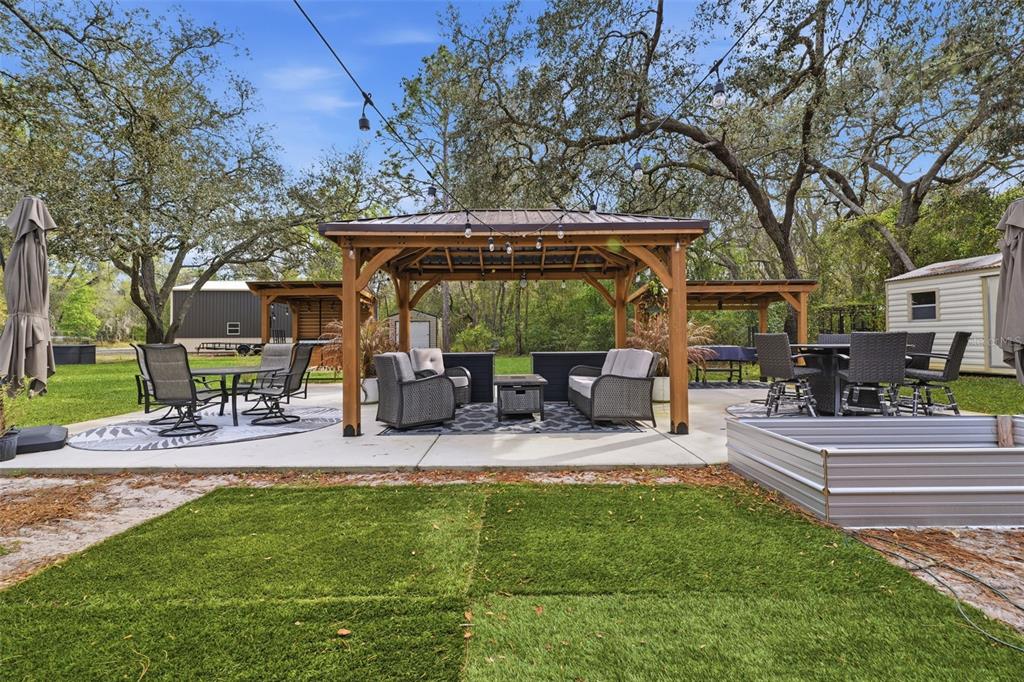 14582 Boland Avenue Spring Hill, FL 34610 - Photo 44 of 74 a view of a patio with table and chairs under an umbrella