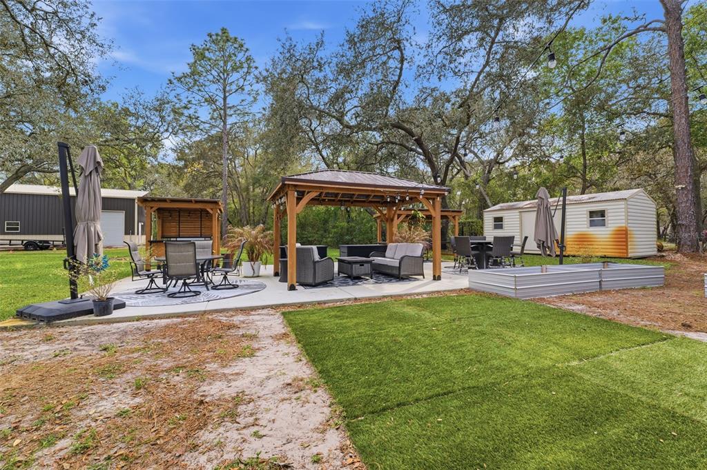 14582 Boland Avenue Spring Hill, FL 34610 - Photo 45 of 74 a view of a backyard with sitting area