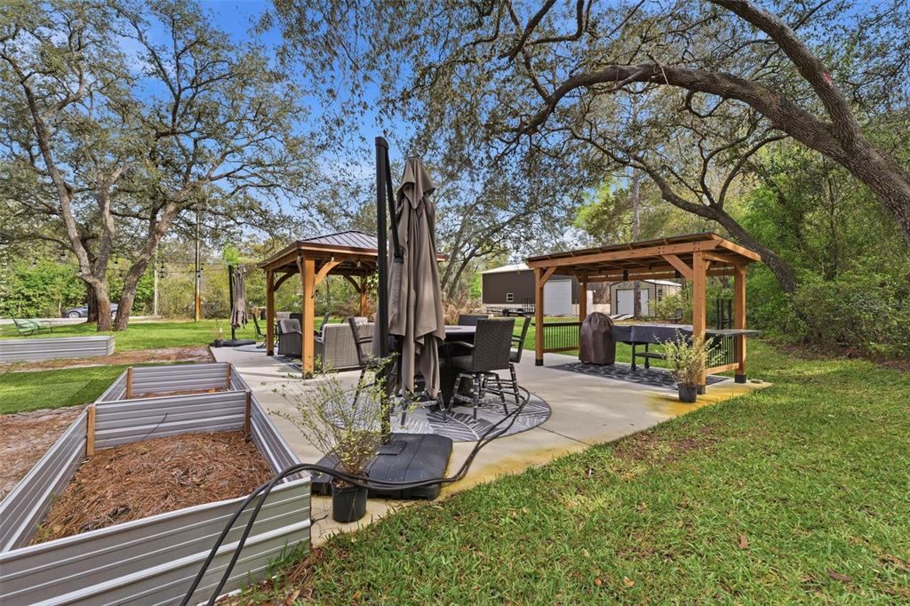14582 Boland Avenue Spring Hill, FL 34610 - Photo 47 of 74 a view of a chair and table in backyard of the house