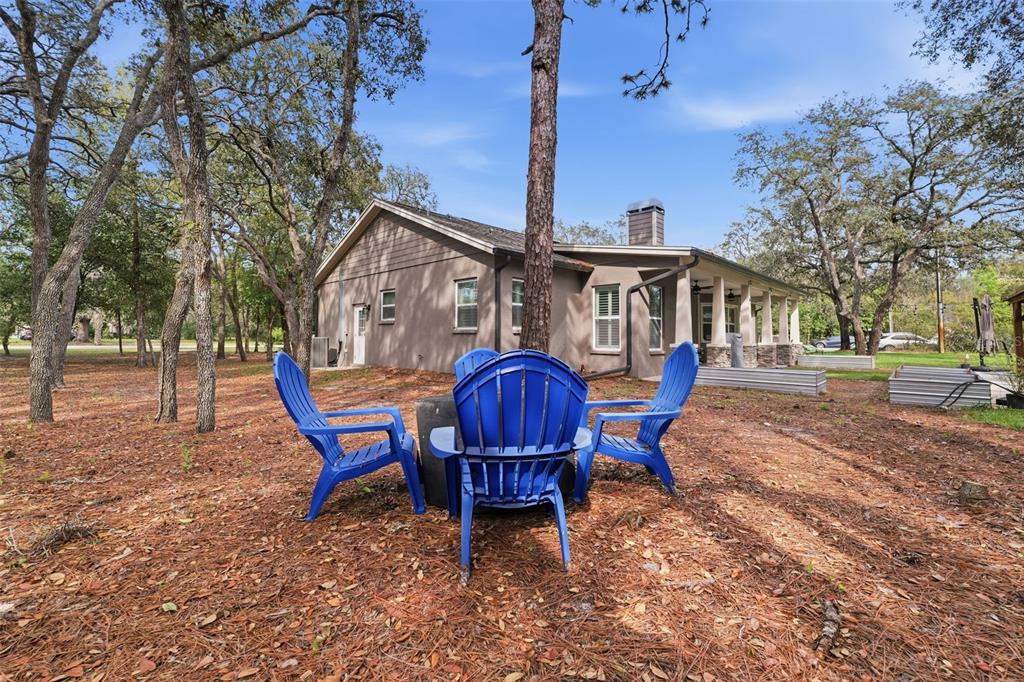 14582 Boland Avenue Spring Hill, FL 34610 - Photo 49 of 74 a view of a house with a chairs in a patio