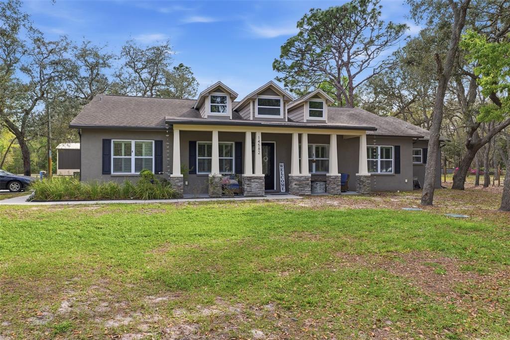14582 Boland Avenue Spring Hill, FL 34610 - Photo 5 of 74 front view of a house with a yard