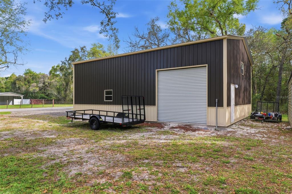 14582 Boland Avenue Spring Hill, FL 34610 - Photo 51 of 74 a view of a house with backyard and sitting area