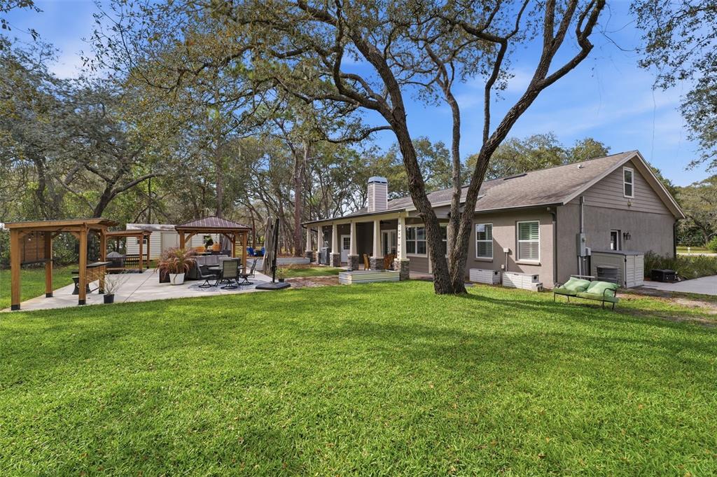 14582 Boland Avenue Spring Hill, FL 34610 - Photo 56 of 74 a view of a house with backyard porch and garden