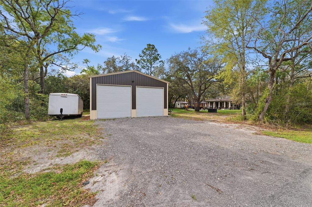 14582 Boland Avenue Spring Hill, FL 34610 - Photo 60 of 74 a view of a house with backyard and a tree